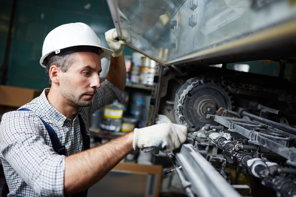 Man-doing-industrial-machinery-repair-